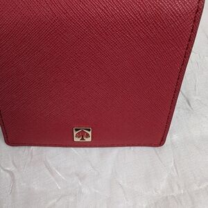 Kate Spade red saffiano wallet with gold spade emblem